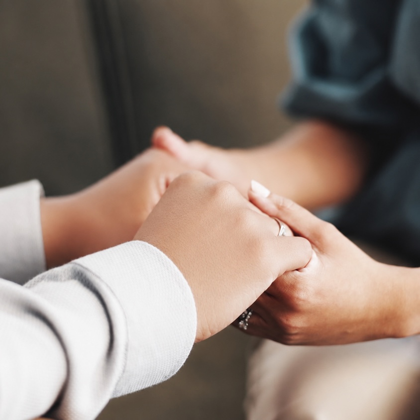Two women holding hands